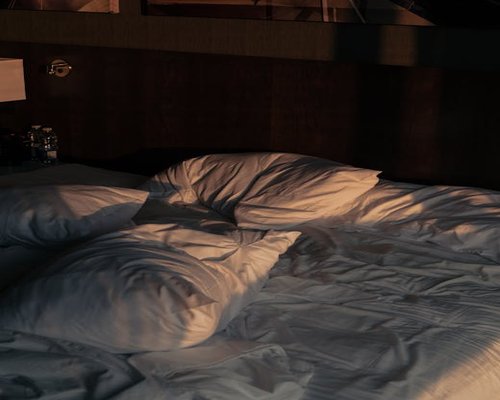 Cozy low-lit bedroom prepared for sleeping