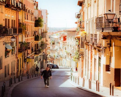 Person walking confidently down a sunny street in Madrid